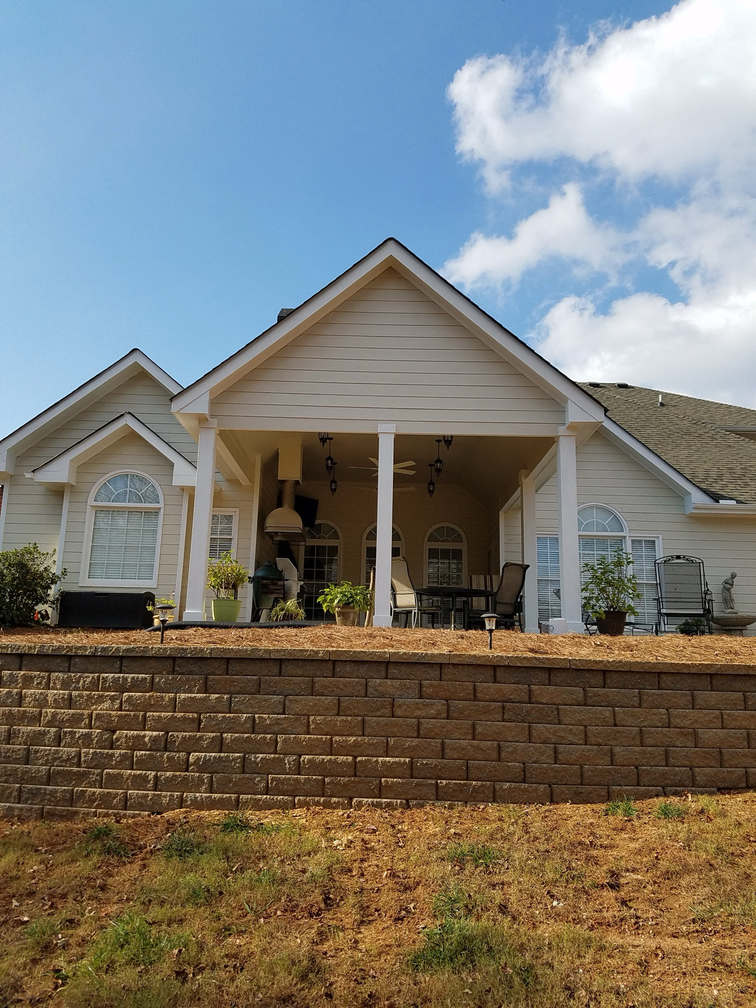 Covered porch exterior with retaining wall — Keystone South Construction Georgia
