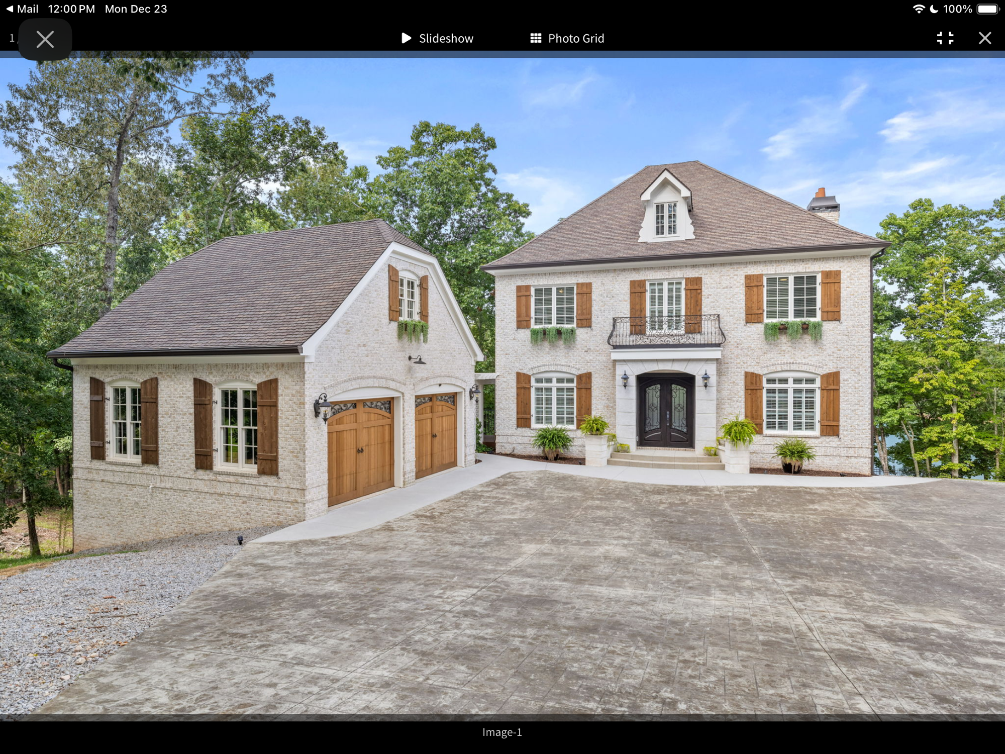 Lake Lanier luxury custom home — white brick exterior with carriage house and iron doors built by Keystone South Construction