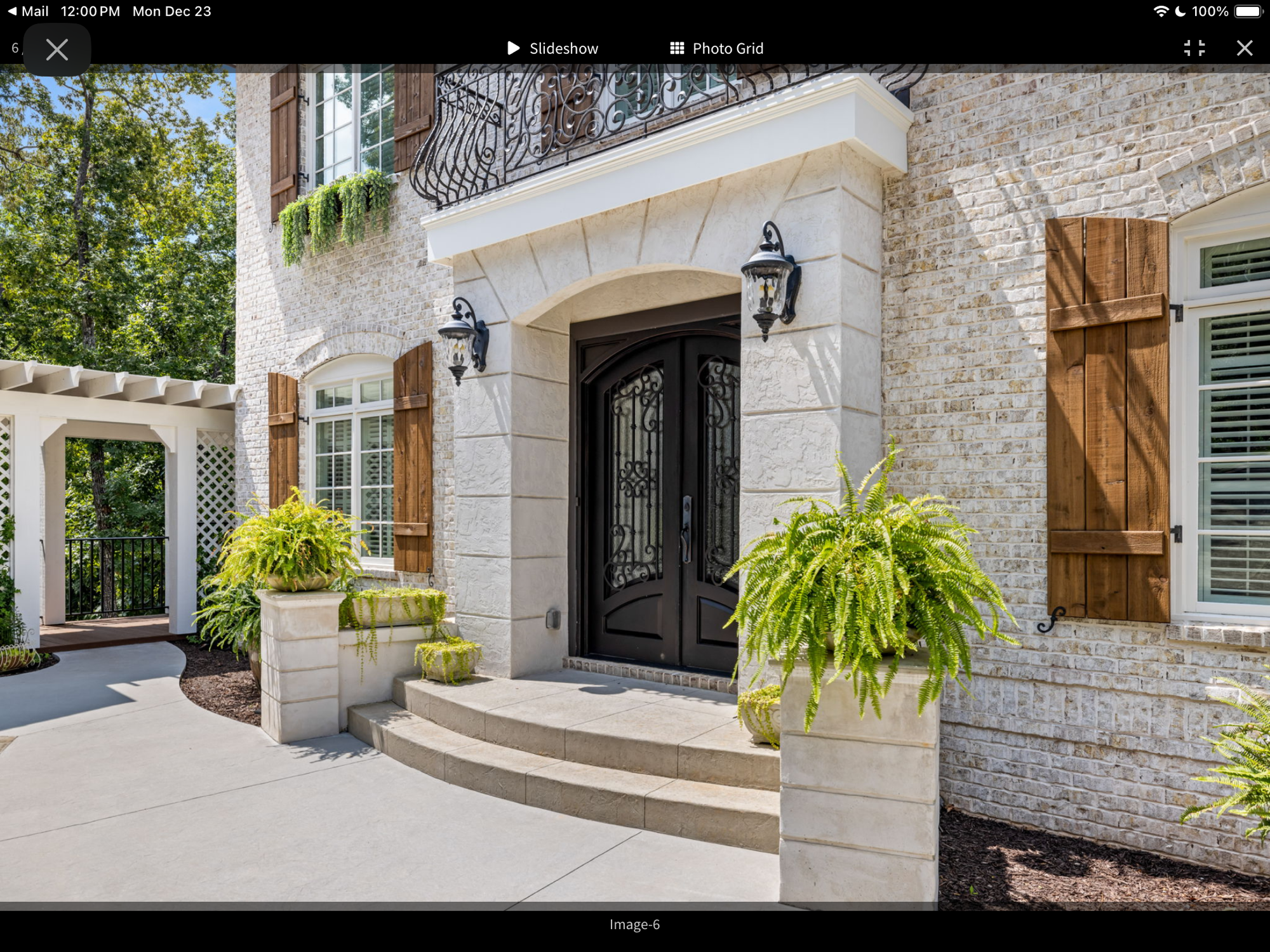 Stone arched entry with iron double doors — Lake Lanier home by Keystone South Construction