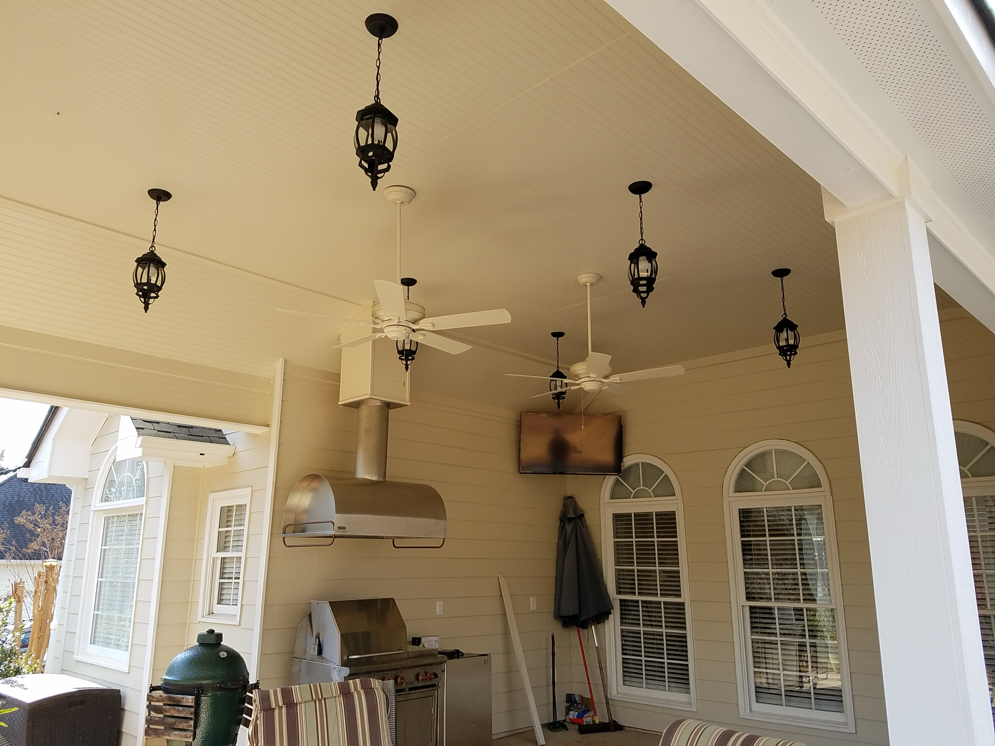 Outdoor kitchen with pendant lanterns and ceiling fans — Keystone South Construction